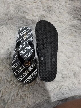 Michael Kors Black Flip-Flop Sandals with Gold Logo Accent